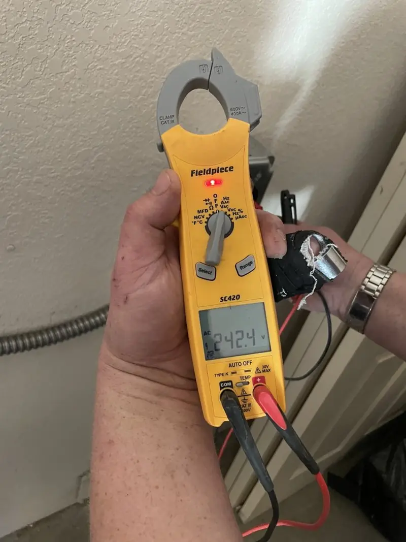 Voltage testing with clamp meter during Electrical Installation Services in Bunk Foss
